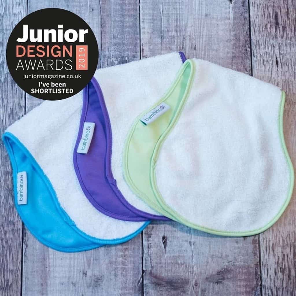 3 bumbinos. blue bumbino, green bumbino and purple bumbino with Junior Design Awards logo. the bumbino is a towel to make nappy-free time easier.