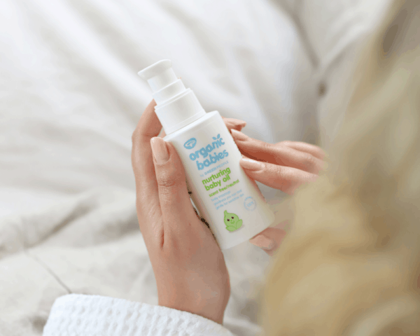 Woman holding Green People Organic Baby Massage Oil