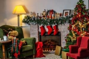 Christmas scene - christmas tree with stockings hanging on the fireplace